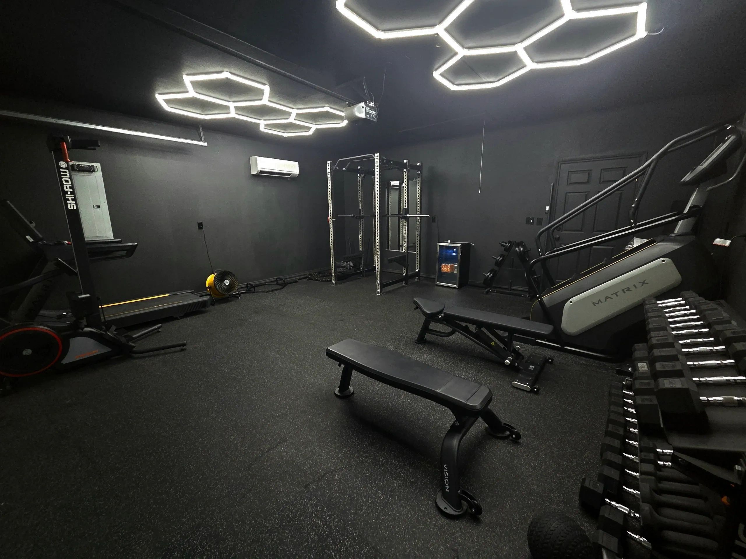 The original Uplift gym in Hico, with strength equipment and hexagonal ceiling lights